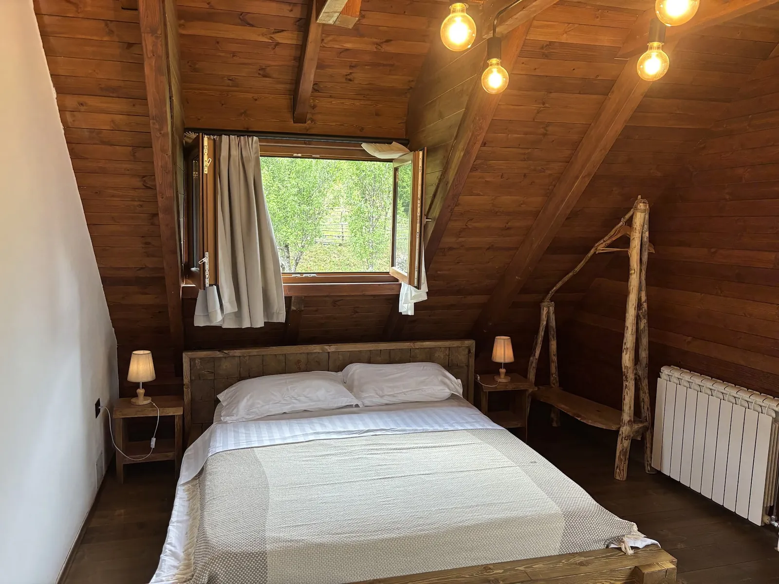 Double bed under the wooden roof